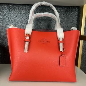 Small red/orange coach purse with strap